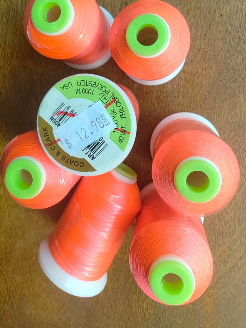 Coats & Clark Thread Spools Bright Orange. True colour is fluorescent orange.